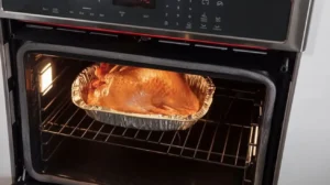 A baking dish in the oven with a seafood boil bag cooking inside.